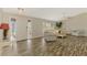 Open living area with wood-look flooring, comfortable seating, and ample natural light at 233 Rotonda Cir, Rotonda West, FL 33947