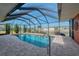 Screened-in pool with brick trim and a safety handrail, offering a relaxing waterfront view and bright, natural lighting at 233 Rotonda Cir, Rotonda West, FL 33947
