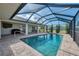 The in-ground pool area is surrounded by a screened-in lanai and backyard views at 233 Rotonda Cir, Rotonda West, FL 33947