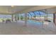 The pool is surrounded by a screened-in lanai with a covered seating area at 233 Rotonda Cir, Rotonda West, FL 33947