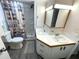 Bathroom features double sinks, tile counters and a lighthouse themed shower curtain at 235 Trailorama Dr, North Port, FL 34287