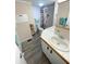 Bathroom features double sinks with tile counters and a lighthouse themed shower curtain at 235 Trailorama Dr, North Port, FL 34287
