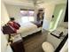 Bedroom features updated flooring, ceiling fan and a large window for plenty of natural light at 235 Trailorama Dr, North Port, FL 34287