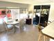 Bright dining area featuring tile flooring, a sliding glass door, and comfortable seating at 235 Trailorama Dr, North Port, FL 34287