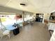 Sunlit dining area with ample seating, tile flooring, and a view to the outside at 235 Trailorama Dr, North Port, FL 34287