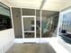 Covered porch with view into screened porch at 235 Trailorama Dr, North Port, FL 34287