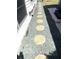Side walkway with shell shaped stepping stones and pebble ground cover at 235 Trailorama Dr, North Port, FL 34287