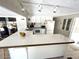 Well-lit kitchen with a large breakfast bar, white cabinets, and modern appliances at 235 Trailorama Dr, North Port, FL 34287