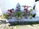 Artistically landscaped garden featuring diverse plants and decorative stone, enhancing curb appeal at 235 Trailorama Dr, North Port, FL 34287