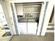 Laundry area featuring a washer, dryer, shelving, and curtain at 235 Trailorama Dr, North Port, FL 34287