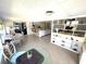 Open concept living and dining area features tile floors, bar seating, and built-in shelving at 235 Trailorama Dr, North Port, FL 34287