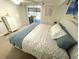 Relaxing bedroom featuring a queen-size bed with beach themed bedding and a view to the lanai at 235 Trailorama Dr, North Port, FL 34287