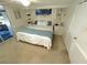 Inviting bedroom with a comfortable queen-size bed and built-in shelving for storage at 235 Trailorama Dr, North Port, FL 34287