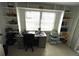 Bright office space featuring built-in shelving, large window, and a desk area at 235 Trailorama Dr, North Port, FL 34287