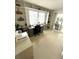 Bright office space featuring built-in shelving, large window, and a desk area at 235 Trailorama Dr, North Port, FL 34287
