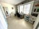 Bright office space featuring built-in shelving, large window, and a desk area at 235 Trailorama Dr, North Port, FL 34287