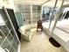 Inviting screened porch with seating, tiled floors, and a sliding glass door at 235 Trailorama Dr, North Port, FL 34287