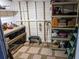 Organized storage area featuring shelving units, work bench, and tiled flooring with gravel accents at 235 Trailorama Dr, North Port, FL 34287