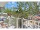 Private balcony with a seating area overlooks the peaceful surroundings and lush greenery at 2405 N Beach Rd # 4, Englewood, FL 34223