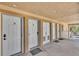 Condo entryway with sightlines to multiple entry doors to units with exterior walkways at 2405 N Beach Rd # 4, Englewood, FL 34223
