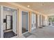 Condo entryway with sightlines to a kitchen with stainless steel appliances and a hallway with storage at 2405 N Beach Rd # 4, Englewood, FL 34223
