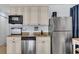 Efficient kitchen featuring stainless steel appliances, granite countertops, and ample storage at 2405 N Beach Rd # 4, Englewood, FL 34223