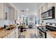 Kitchen with granite countertops, stainless appliances, opening into a living and dining space at 2405 N Beach Rd # 4, Englewood, FL 34223