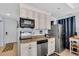 Well-organized kitchen with stainless steel appliances, granite counters, and neutral cabinets at 2405 N Beach Rd # 4, Englewood, FL 34223
