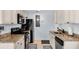 Modern kitchen with granite counters, stainless appliances, sleek white cabinets, and tiled flooring at 2405 N Beach Rd # 4, Englewood, FL 34223