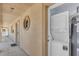 Hallway with a stacked washer and dryer behind a door, providing convenient laundry access at 2405 N Beach Rd # 4, Englewood, FL 34223