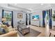 Living room features neutral furnishings and decor, a media center, and tile floors at 2405 N Beach Rd # 4, Englewood, FL 34223