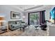 Serene living room featuring soft seating, stylish decor, and a scenic balcony view at 2405 N Beach Rd # 4, Englewood, FL 34223