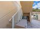 Staircase with white railing leading to the upper level of the building at 2405 N Beach Rd # 4, Englewood, FL 34223