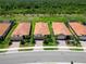 Aerial view showcases well-maintained homes with tile roofs and lush landscaping at 24153 Spartina Dr, Venice, FL 34293