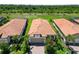 Aerial view of homes with tile roofs and lush landscaping at 24153 Spartina Dr, Venice, FL 34293