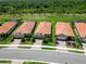 Aerial view showcases well-maintained homes with tile roofs and lush landscaping at 24153 Spartina Dr, Venice, FL 34293