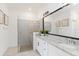 Elegant bathroom featuring a glass-enclosed shower, granite countertops, and ample vanity space at 24153 Spartina Dr, Venice, FL 34293