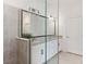 Stylish bathroom featuring a double vanity with granite countertops, and glass shower at 24153 Spartina Dr, Venice, FL 34293