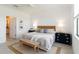 Inviting bedroom featuring a queen bed, sleek navy nightstands, and calming decor at 24153 Spartina Dr, Venice, FL 34293