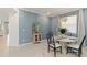 Modern dining room featuring unique chairs, a decorative hutch, and paneled walls at 24153 Spartina Dr, Venice, FL 34293