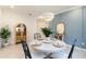 Dining area with a table, accent wall, and decorative lighting fixture at 24153 Spartina Dr, Venice, FL 34293