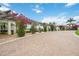 Charming entrance with lush landscaping and colorful bougainvillea, leading to a well-maintained community at 24153 Spartina Dr, Venice, FL 34293