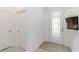 Bright foyer features beautiful tile flooring and decorative front door with sidelights at 24153 Spartina Dr, Venice, FL 34293