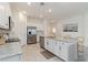 Bright kitchen featuring granite countertops, an island, and stainless steel appliances at 24153 Spartina Dr, Venice, FL 34293