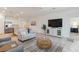Bright living room with neutral tones, tile floors, and modern furnishings at 24153 Spartina Dr, Venice, FL 34293