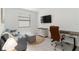 Functional office space with a desk, chair, and a comfortable seating area at 24153 Spartina Dr, Venice, FL 34293