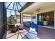 Enjoy the screened-in patio with outdoor seating, ceiling fan, and yard views at 24153 Spartina Dr, Venice, FL 34293