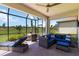 Covered patio with lounge seating, table, ceiling fan and view of the green lawn at 24153 Spartina Dr, Venice, FL 34293