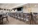 Restaurant bar with brown chairs, TV, and a view of the outdoor area at 24153 Spartina Dr, Venice, FL 34293