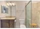 Bathroom featuring a single vanity, a toilet, and a glass-enclosed shower with tile surround at 24193 Gallberry Dr, Venice, FL 34293